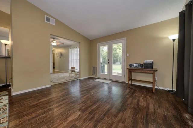a view of a livingroom with wooden floor and a window