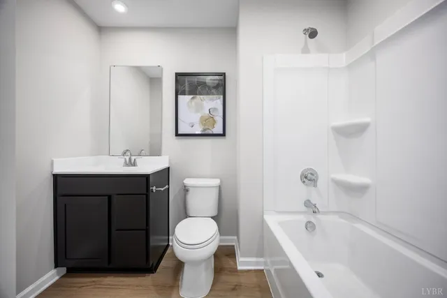 a bathroom with a sink a toilet and bathtub