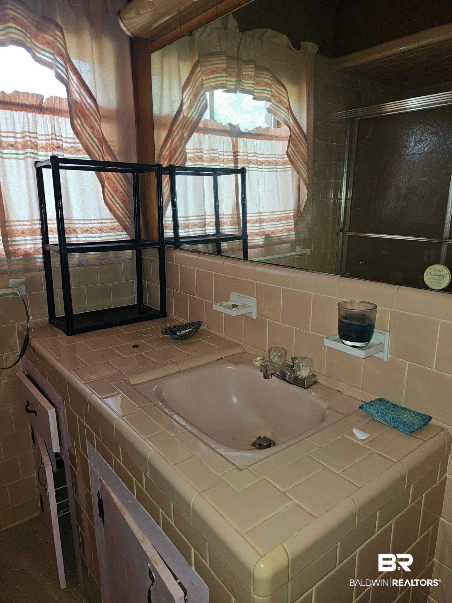 304 Sutherland Drive Mobile, AL 36611 - Photo 8 of 18 Bathroom featuring vanity, decorative backsplash, and a shower with shower door