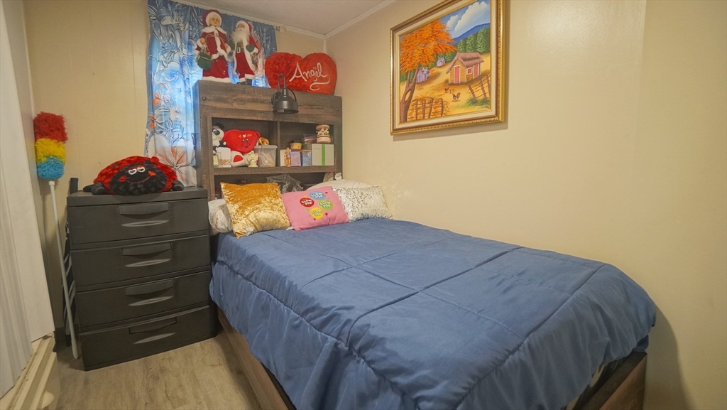 93 Grochmal Avenue, Unit 126 Springfield, MA 01151 - Photo 26 of 35 a bedroom with a bed and wall painting