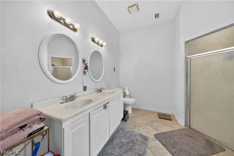 a bathroom with a double vanity sink and a mirror