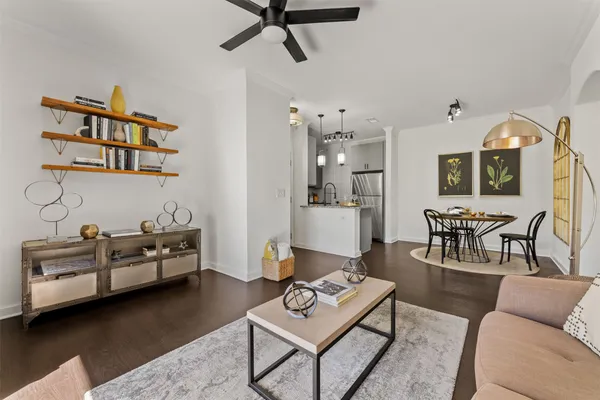 a living room with furniture and wooden floor