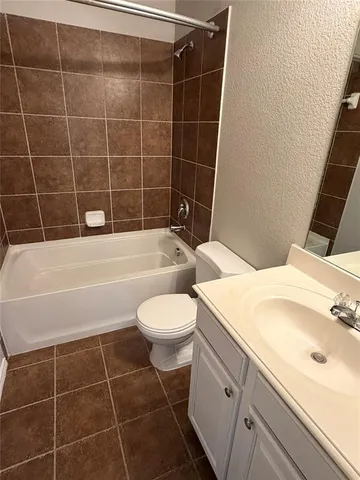 a bathroom with a toilet a sink and bathtub