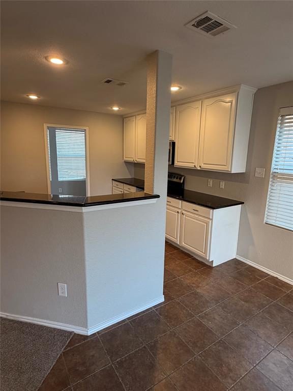 3604 Monte Verde Way Denton, TX 76208 - Photo 6 of 24 a large kitchen with stainless steel appliances a large counter top and a stove