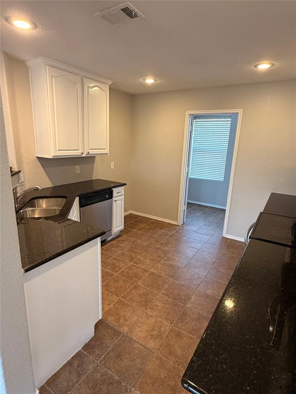 3604 Monte Verde Way Denton, TX 76208 - Photo 7 of 24 a kitchen with granite countertop a sink and a stove top oven