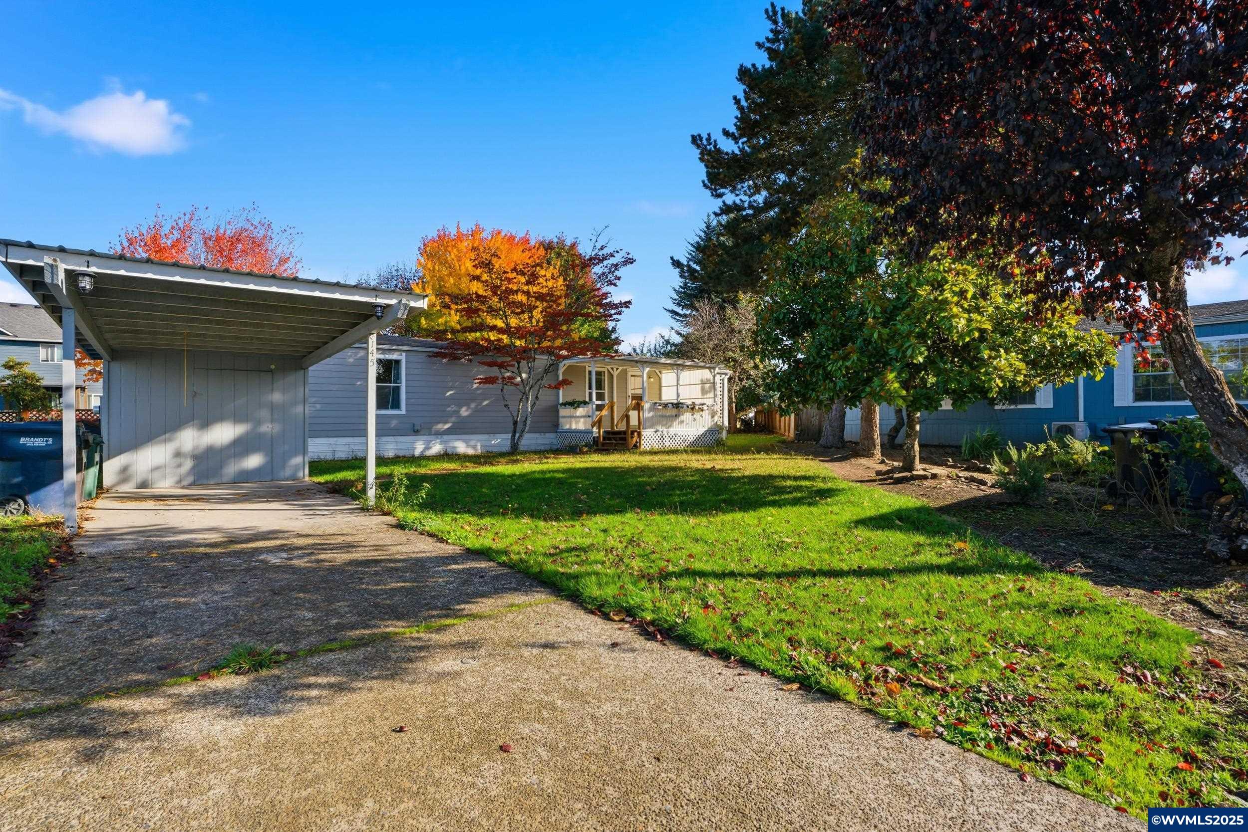 277 Edwards Road, Unit 145 Monmouth, OR 97361 - Photo 37 of 47 a front view of a house with a yard table and chairs