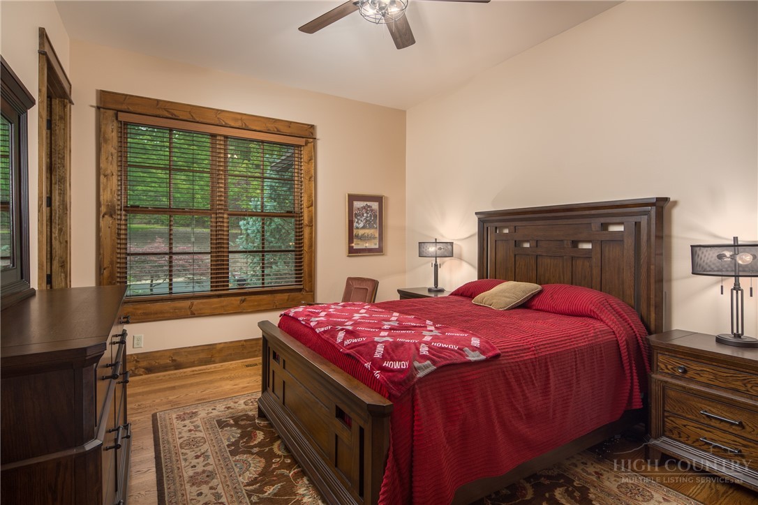 115 Passionflower Trail Boone, NC 28607 - Photo 29 of 50 a bedroom with a bed and a chandelier