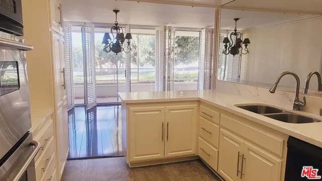 a kitchen with sink a refrigerator and window