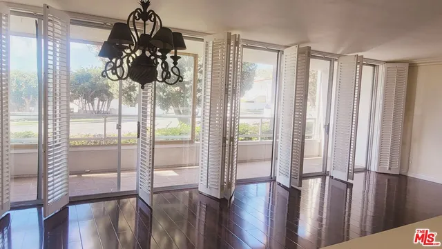 a view of a room with wooden floor and windows