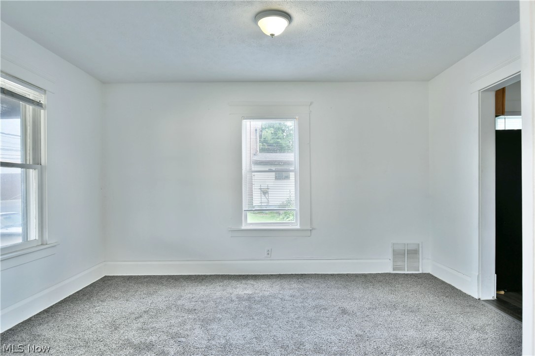 3617 South Main Street Mineral Ridge, OH 44440 - Photo 11 of 34 Empty room with carpet and a textured ceiling