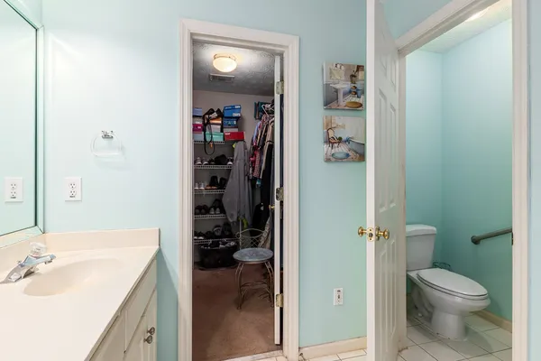 a bedroom with a bed and a chandelier fan