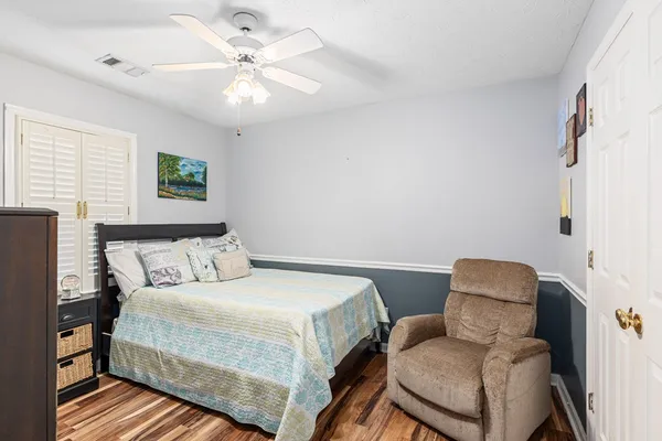 a bedroom with a bed and a chandelier