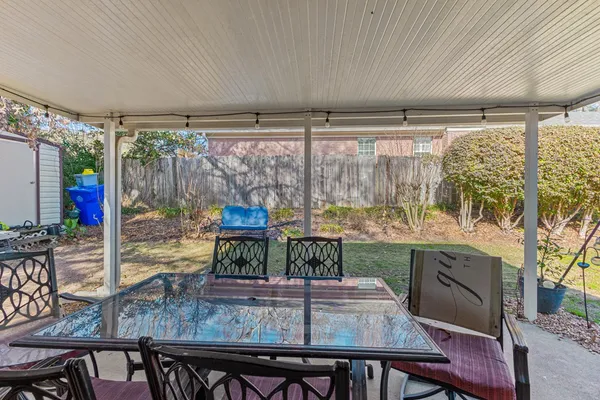 a view of a house with backyard porch and sitting area