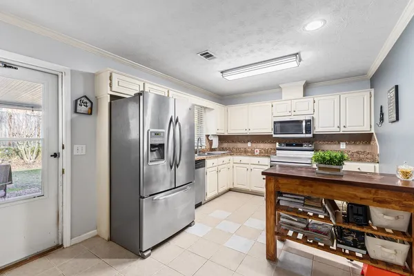 a kitchen with granite countertop cabinets stainless steel appliances and a sink