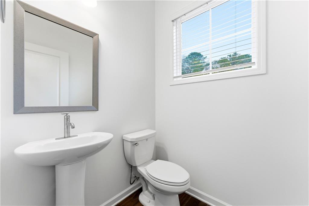 1621 Avery Way Tucker, GA 30084 - Photo 18 of 29 a bathroom with a toilet sink and mirror