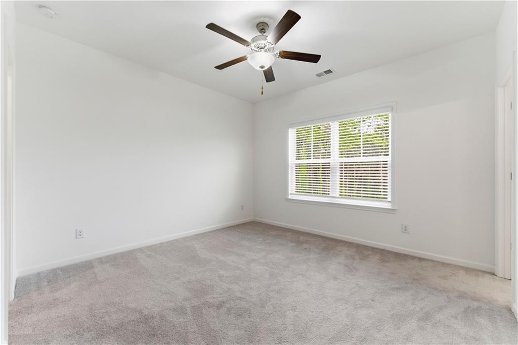 1621 Avery Way Tucker, GA 30084 - Photo 21 of 29 an empty room with ceiling fan and window