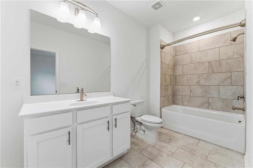 1621 Avery Way Tucker, GA 30084 - Photo 22 of 29 a bathroom with a sink a toilet and shower