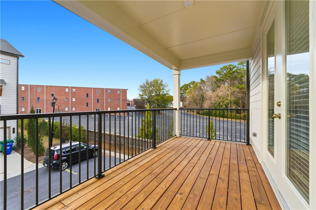 1621 Avery Way Tucker, GA 30084 - Photo 28 of 29 a balcony with wooden floor and iron stairs