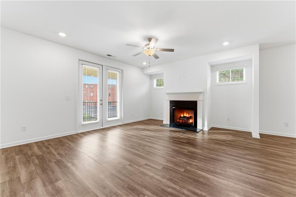 1621 Avery Way Tucker, GA 30084 - Photo 8 of 29 a view of an empty room with wooden floor fireplace and a window