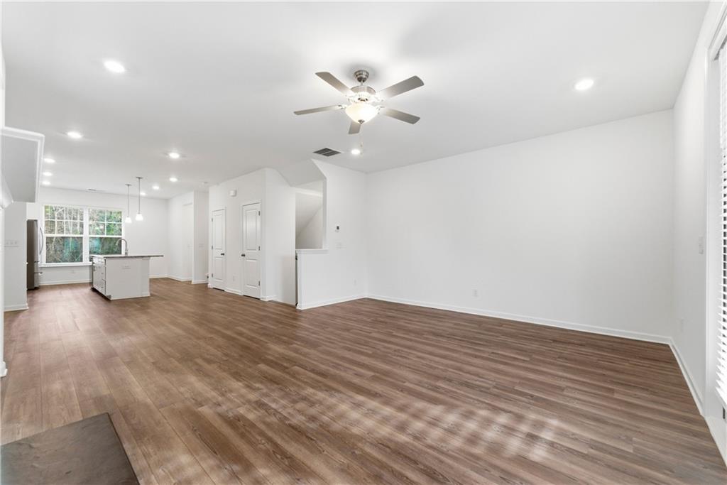 1621 Avery Way Tucker, GA 30084 - Photo 9 of 29 a view of an empty room with wooden floor and a ceiling fan