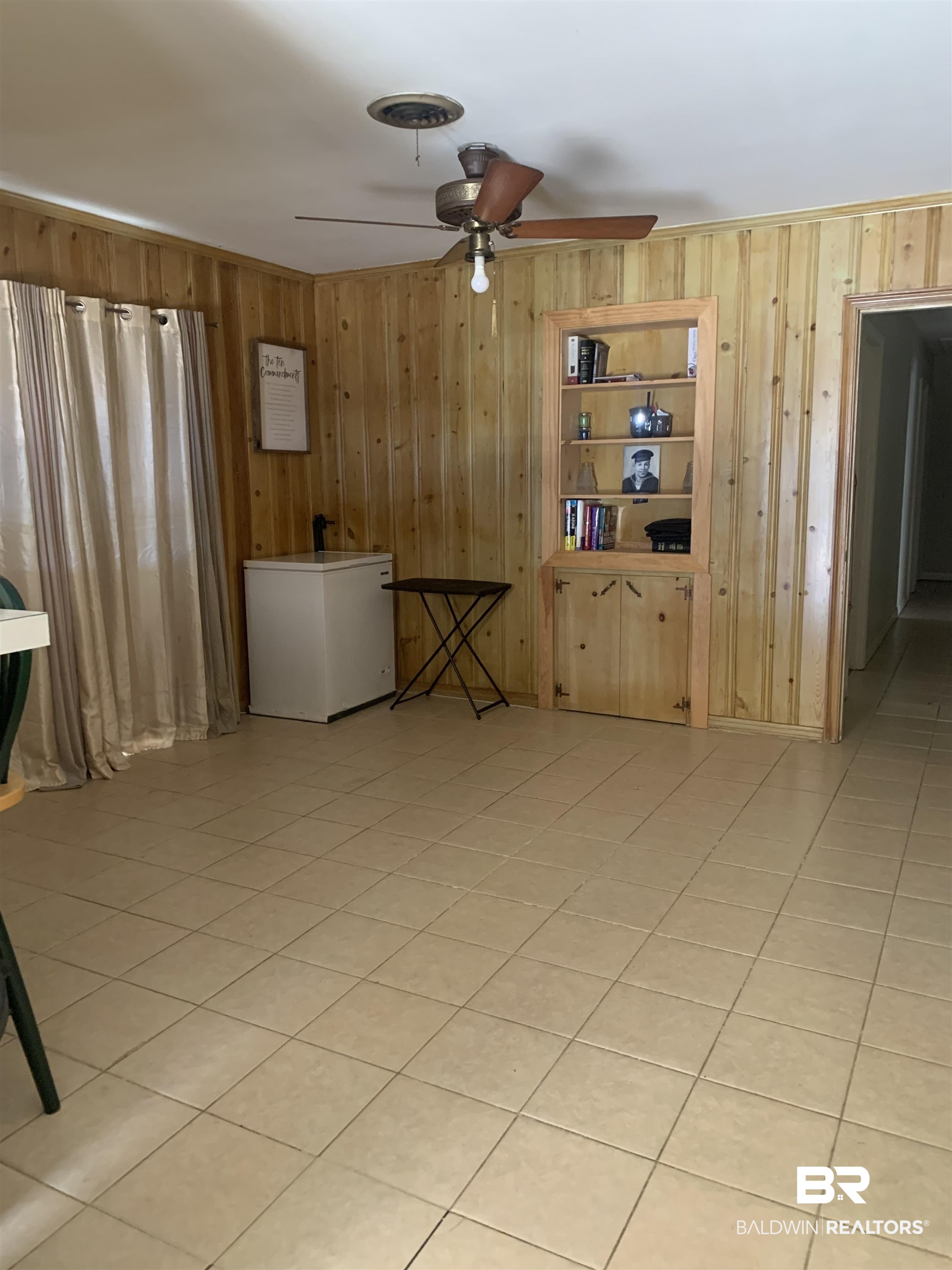 5467 Racine Avenue Mobile, AL 36618 - Photo 3 of 11 Tiled spare room featuring ceiling fan and wood walls