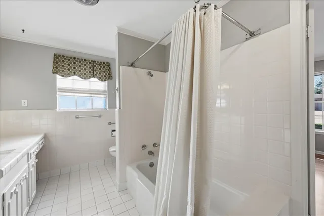 a bathroom with a granite countertop shower mirror and a sink