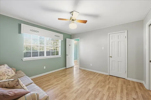 a view of a livingroom with wooden floor and a window