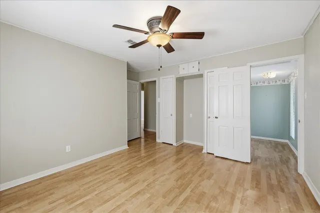 a view of an empty room and wooden floor
