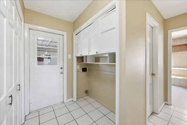 a view of kitchen space with refrigerator cabinets and window