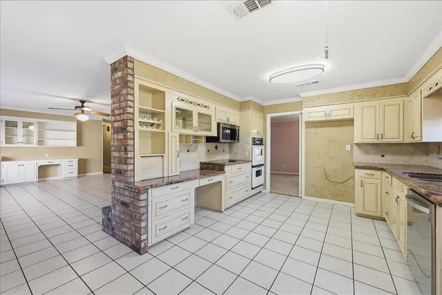 a kitchen with stainless steel appliances a stove a sink and cabinets