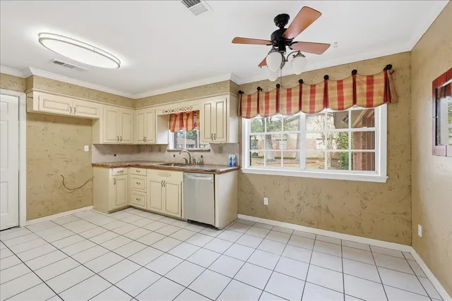 a kitchen with a sink cabinets and window