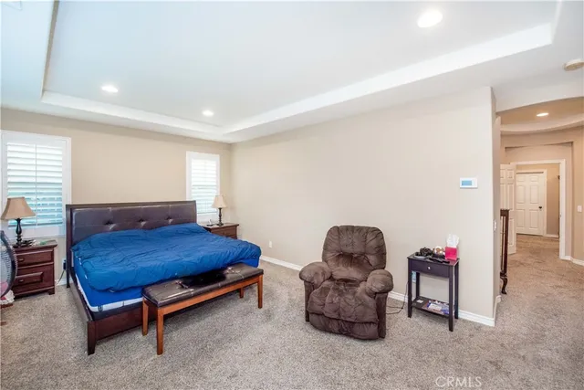 a bedroom with furniture and a chair