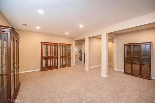 a view of an empty room with closet and bathroom