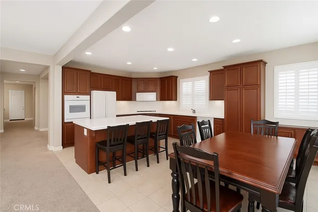 a large kitchen with a table and chairs