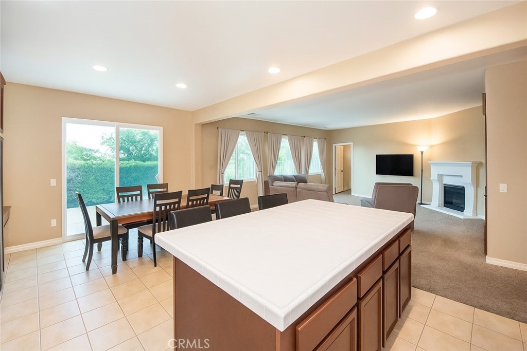 17094 Noble View Circle Riverside, CA 92503 - Photo 6 of 29 a large kitchen with kitchen island a sink table and chairs