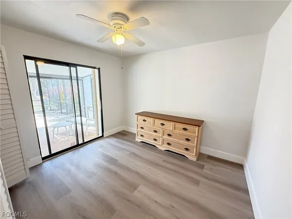 an empty room with windows and cabinet