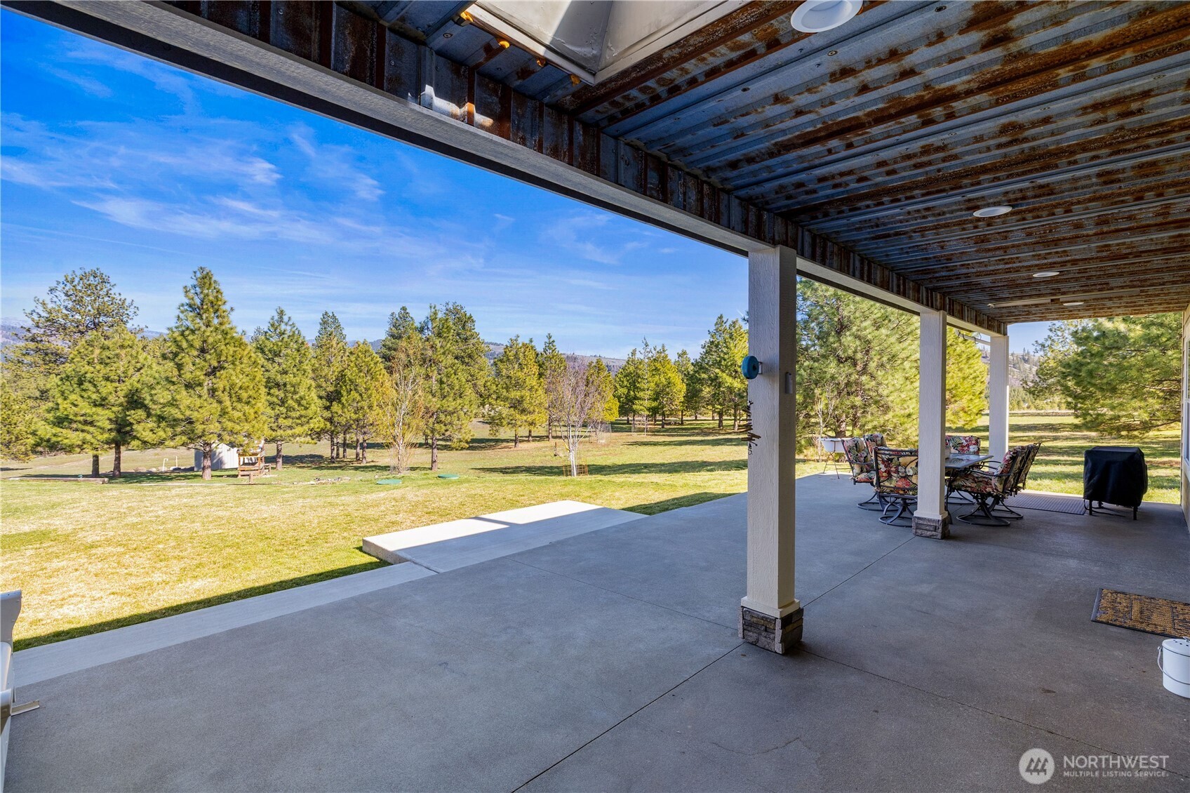 710 Hidden Valley Road Cle Elum, WA 98922 - Photo 24 of 35 a view of a swimming pool with outdoor seating and a floor to ceiling window