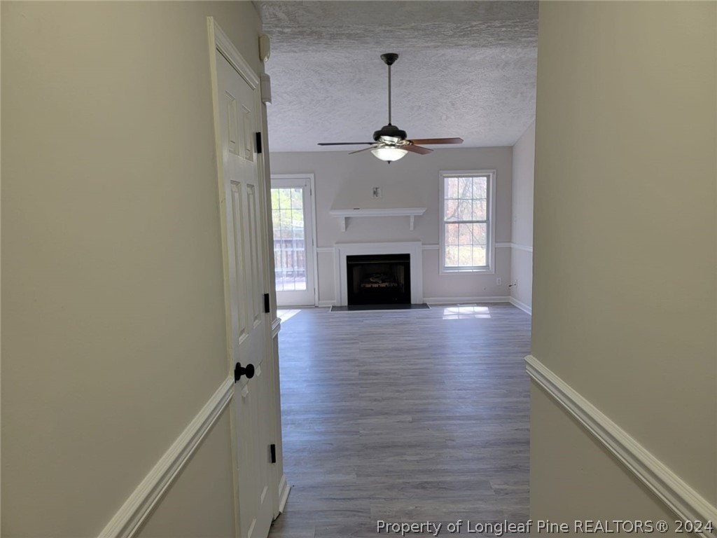 191 Rye Lane Raeford, NC 28376 - Photo 11 of 44 en empty room with wooden floor fireplace and window