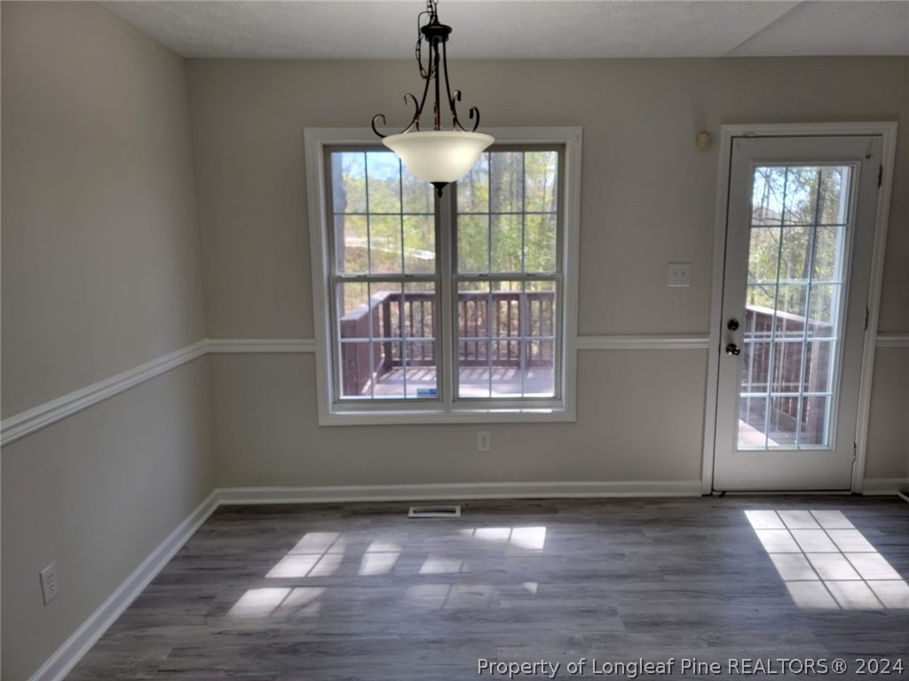 191 Rye Lane Raeford, NC 28376 - Photo 17 of 44 a view of an empty room with wooden floor and a window