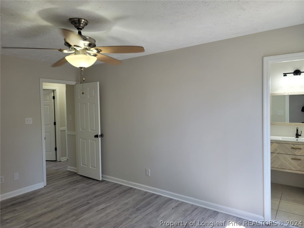 191 Rye Lane Raeford, NC 28376 - Photo 38 of 44 a view of a chandelier fan and wooden floor