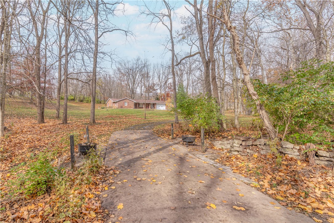 18333 Lefevre Number 2 Road Sidney, OH 45365 - Photo 8 of 25 A private driveway leads through a wooded landscape to a charming residence.