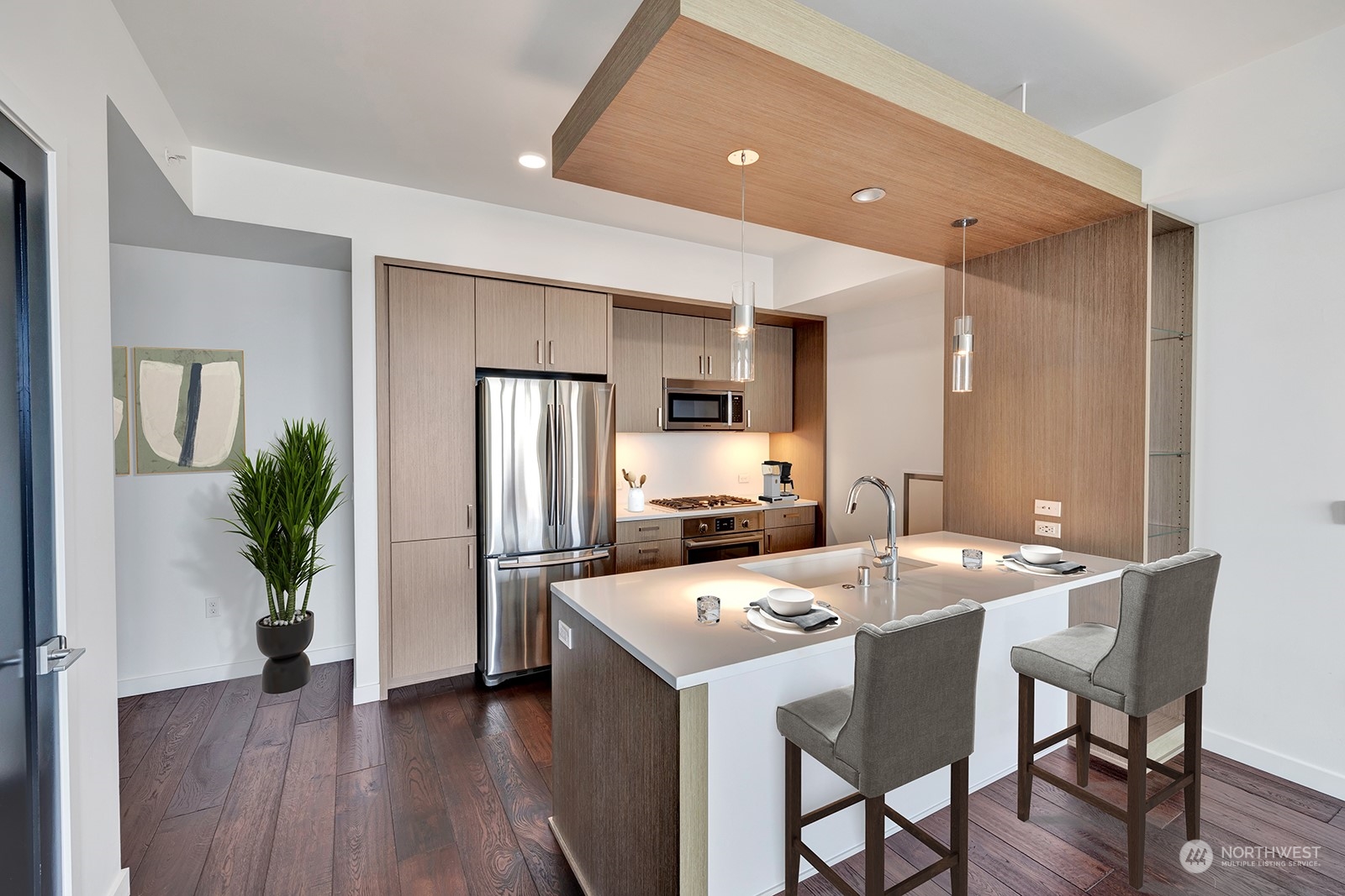 1321 Seneca Street, Unit 1708 Seattle, WA 98101 - Photo 4 of 14 a kitchen with a table chairs refrigerator and microwave