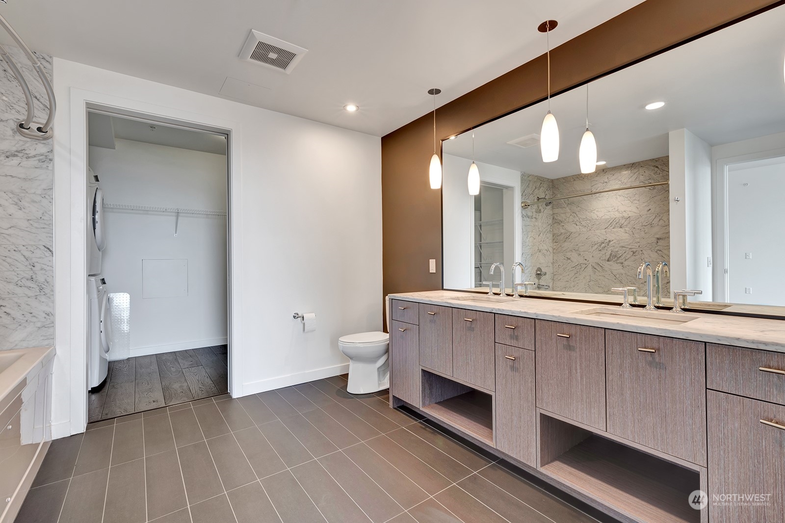 1321 Seneca Street, Unit 1708 Seattle, WA 98101 - Photo 7 of 14 a bathroom with a double vanity sink a toilet and a large mirror