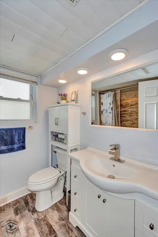 a bathroom with a sink toilet and a mirror