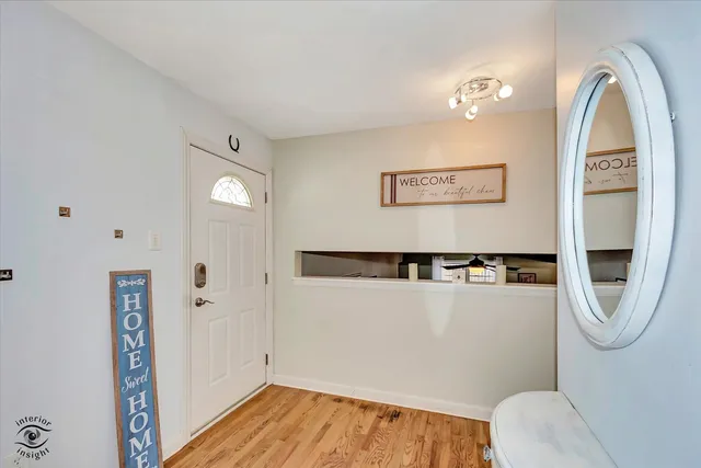 a view of a room with wooden floor and cabinet