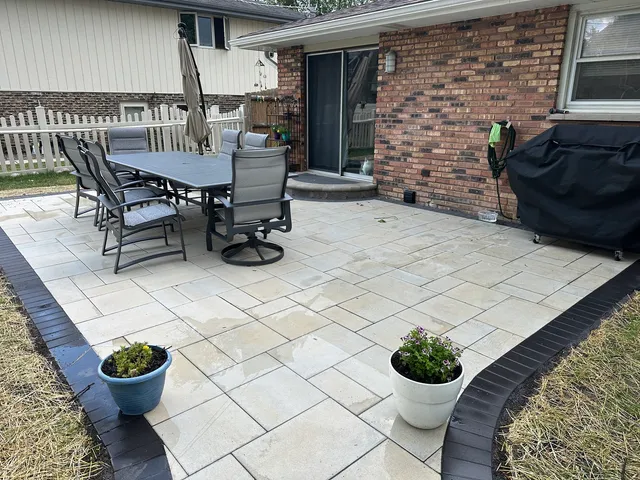 a dining room with furniture and a potted plant