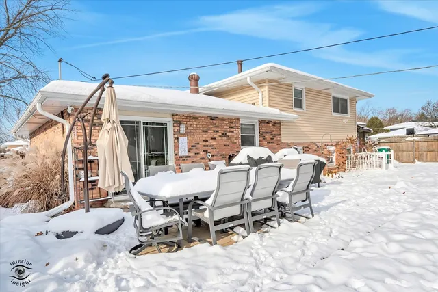 a view of a patio with table and chairs