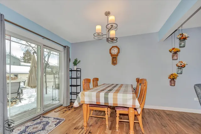 a view of a dining room with furniture wooden floor and front door