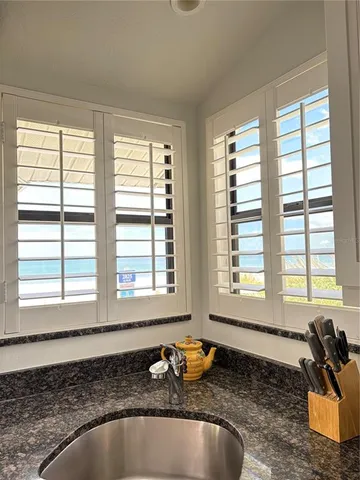 a kitchen with granite countertop sink and window