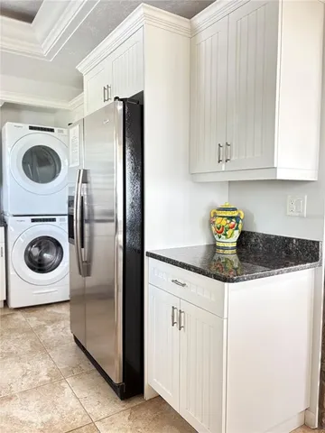 a kitchen with a refrigerator and cabinets